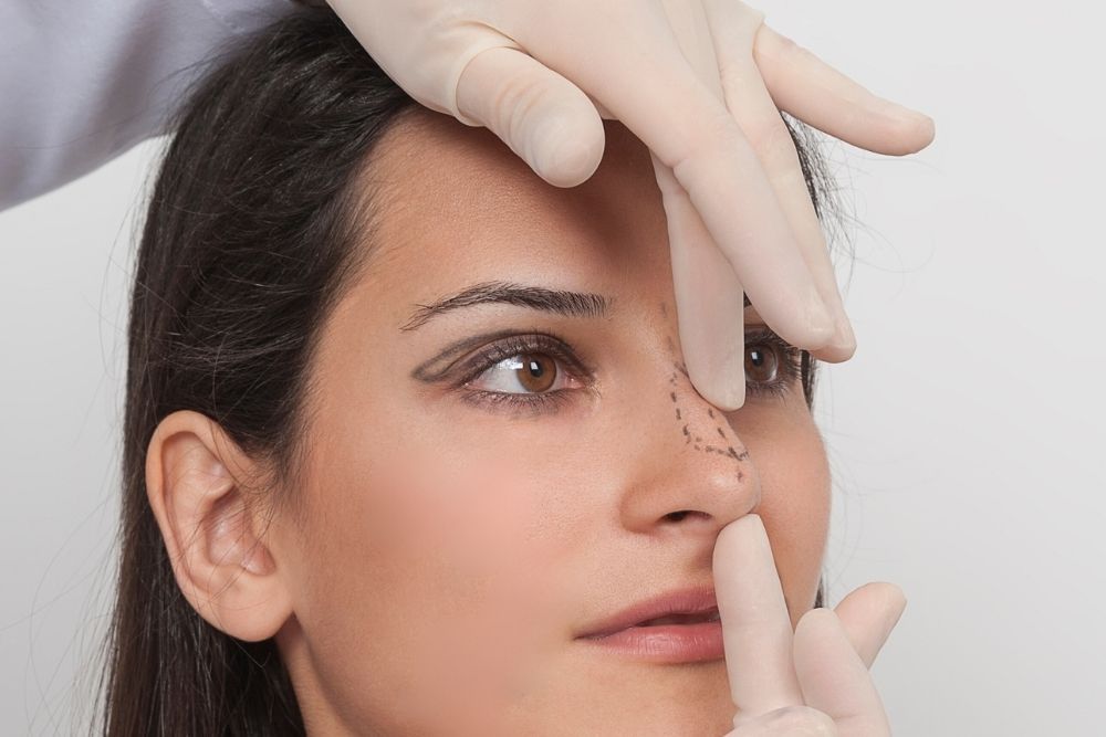 Woman getting examination before nose surgery