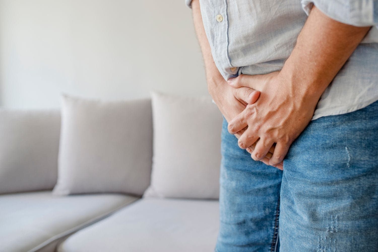 Man holding his crotch because of testicular inflammation