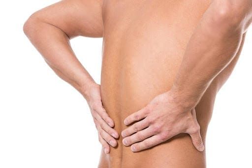 Man holding his back because of kidney infection